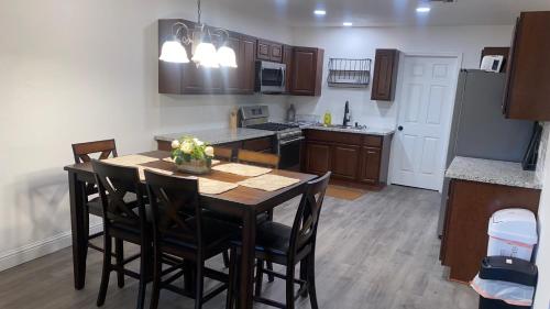 a kitchen with a table and chairs in a kitchen at Entire cozy home in Madera