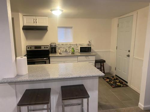 a kitchen with a counter and a stove top oven at Entire cozy home in Madera