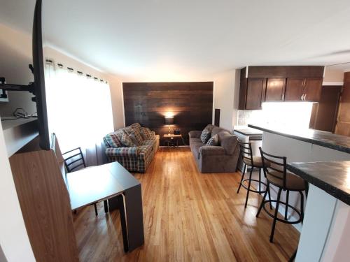 a kitchen and living room with a couch and a table at Chill Retreat in great location (parking onsite) in Wilmington