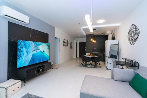 a living room with a large flat screen tv at Arena MALL Galleria View and Securities Parking1 in Burgas City