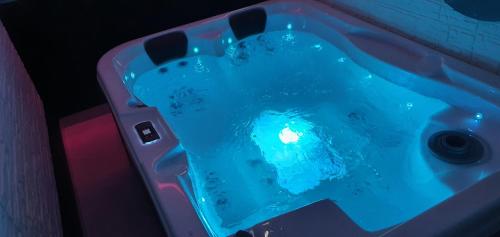 a bath tub with blue water in it at Aurora Lux Spa Smart apartments in Belgrade