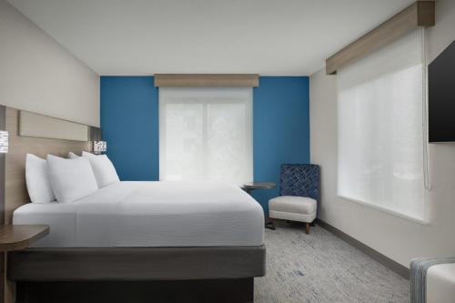a hotel room with a bed and a chair at Holiday Inn Express & Suites Superior by IHG in Superior