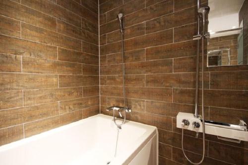 a bathroom with a bath tub and a shower at Ulsan Samsan Pandora Hotel in Ulsan