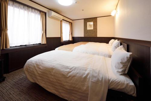 Postel nebo postele na pokoji v ubytování Belmont Hotel