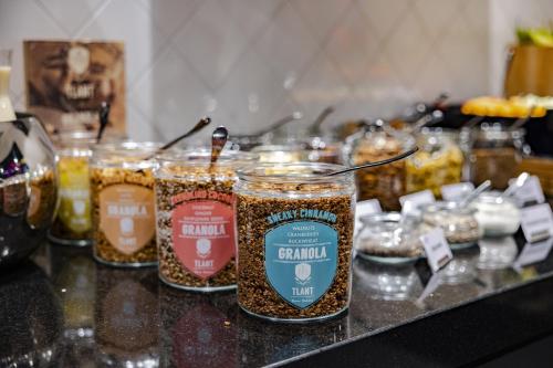 a group of jars of food sitting on a counter at Crowne Plaza Amsterdam - South by IHG in Amsterdam