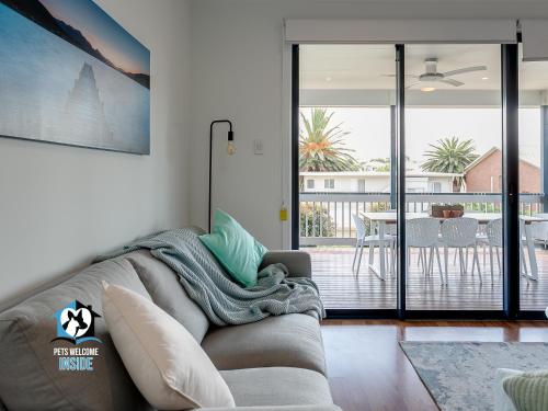 a living room with a couch and a balcony at 4BR Contemporary Coastal Home with Rural Outlook in Port Elliot