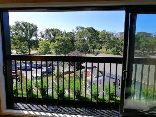 a view of a parking lot from a window at Cozy 1BR Apartment with Hagley Park View in Christchurch