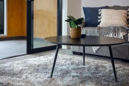 a coffee table in a living room with a couch at Hagley Park Apartment in Christchurch