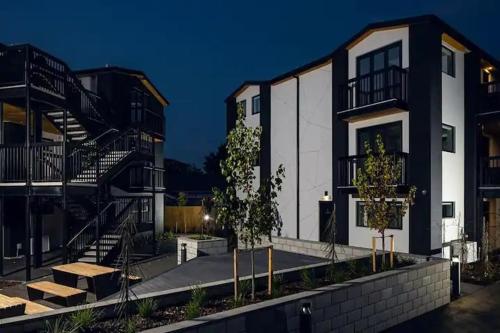 a group of buildings with stairs in front of them at Cozy 1BR Apartment with Hagley Park View in Christchurch