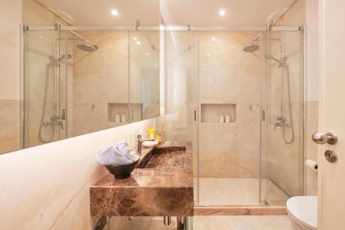 a bathroom with a shower and a sink at Sunny Beach Oasis, By TimeCooler in Oeiras