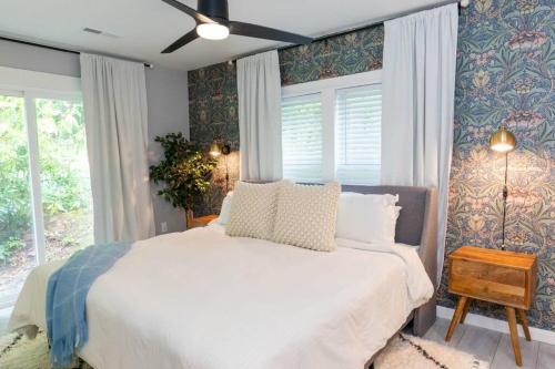 a bedroom with a white bed and a window at Parker House - 15 mins to Downtown Asheville in Fairview