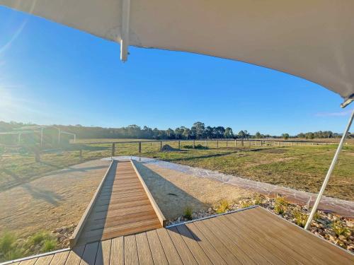 a wooden deck with a view of a field at Kangaroo Paw @ The Beltree in Belford