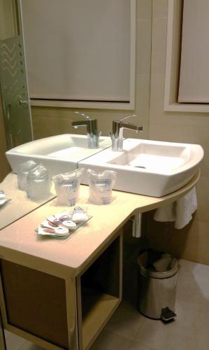 a bathroom with a sink and a counter with towels at Isla Nova Hotel in Foz