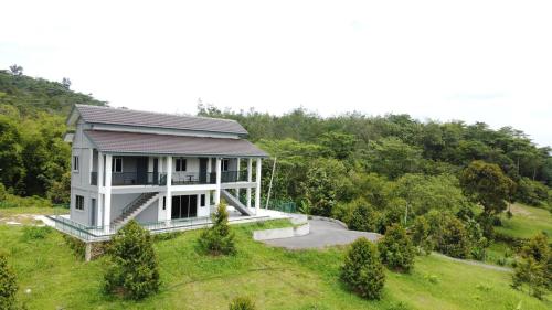 a house on top of a hill with trees at Villa with Titiwangsa Hill View in Kerling