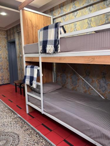 two bunk beds in a room with a bed at InJoy in Shymkent