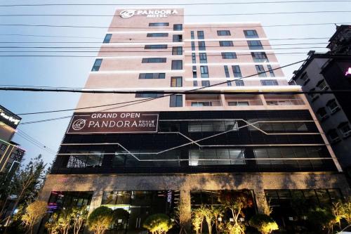 a tall building with a sign in front of it at Ulsan Samsan Pandora Hotel in Ulsan
