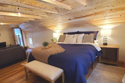 a bedroom with a large bed with a wooden wall at Sequoia Glen in Wilsonia