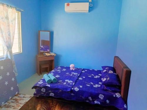A bed or beds in a room at Teratak Desa Umaira