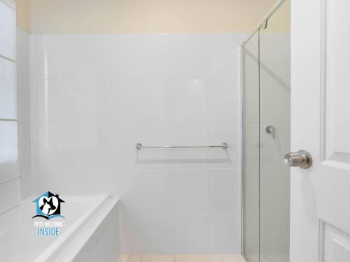 a bathroom with a shower with a glass door at Sweeping Ocean Views 4BR on One Acre in Encounter Bay