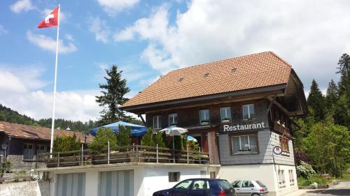 a building with a flag on top of it at Gastwirtschaft Hornbach-pinte in Wasen