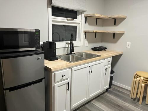 a kitchen with a sink and a microwave at Lake Shafer Resort in Monticello