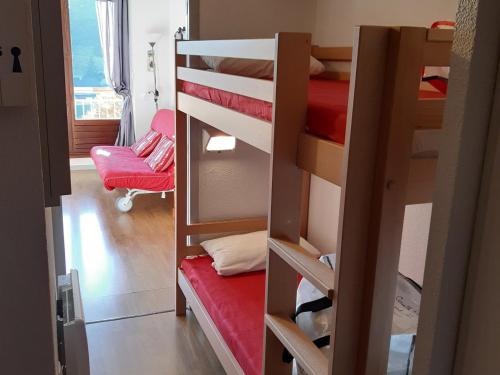 a room with two bunk beds and a room with a chair at Studio cabine avec balcon et parking à Villard-de-Lans - FR-1-515-177 in Villard-de-Lans