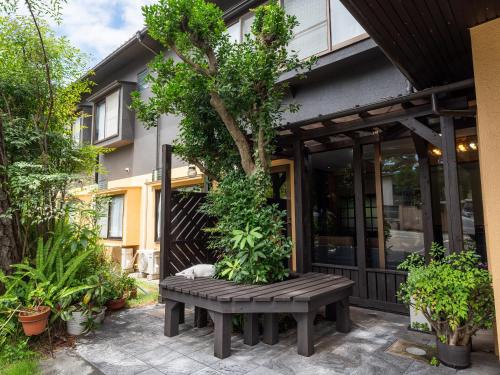 a wooden bench sitting in front of a building at SUIHOUEN in Numazu