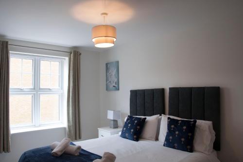 a bedroom with a bed with a large window at Watford Gemini Hurst in Watford