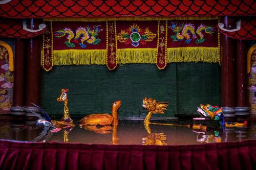 a group of animals on a stage in a room at Okaeri Homestay in Hanoi
