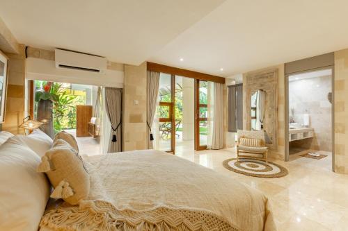 a bedroom with a large bed and a bathroom at PROMO! Luxury Villa Escape in Ubud 2 BR in Ubud