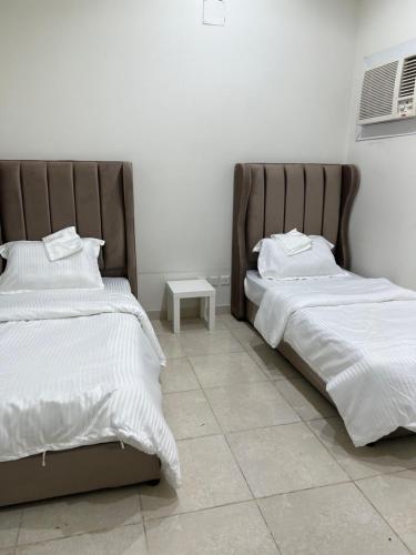 two beds sitting next to each other in a bedroom at شقق مفروشة in Riyadh