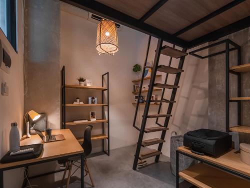 a room with a desk and a loft bed at Cove Hillcrest in Buaran