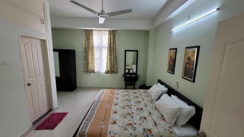 a bedroom with a bed and a ceiling fan at Vazeer Residancy in Hyderabad