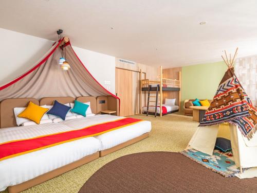 a bedroom with a bed with a tent in it at Kirishima Kokusai Hotel in Kirishima