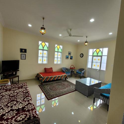 a living room with a couch and stained glass windows at Vazeer Residancy in Hyderabad
