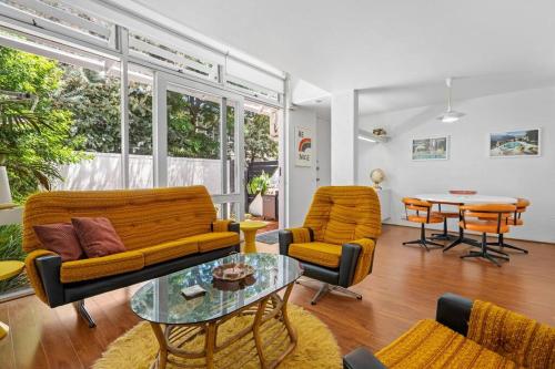a living room with a couch and chairs and a table at The Warbling Magpie in Melbourne