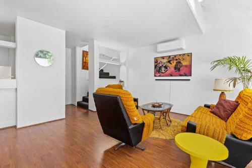 a living room with a couch and chairs and a table at The Warbling Magpie in Melbourne