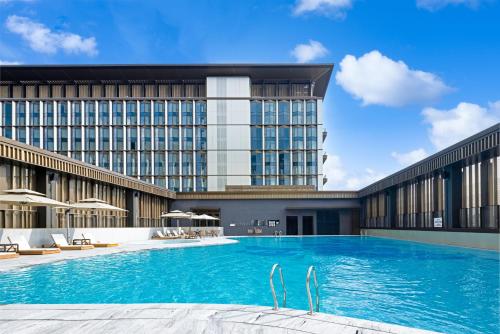 a large swimming pool in front of a building at Four Points by Sheraton Guangzhou, Baiyun in Guangzhou