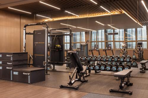 a gym with dumbbells and equipment in a room at Four Points by Sheraton Guangzhou, Baiyun in Guangzhou