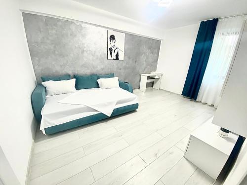 a bedroom with a bed and a table in it at City Center Apartment in Tulcea