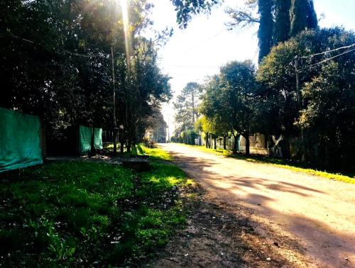 a dirt road with trees on the side of it at Casa Quinta Tigre Benavidez in Benavídez