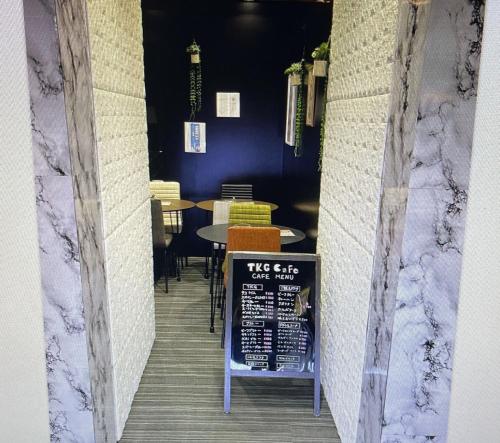 a dining room with a table and a sign on the wall at Fujiko Building 3F - Vacation STAY 35722v in Yokosuka