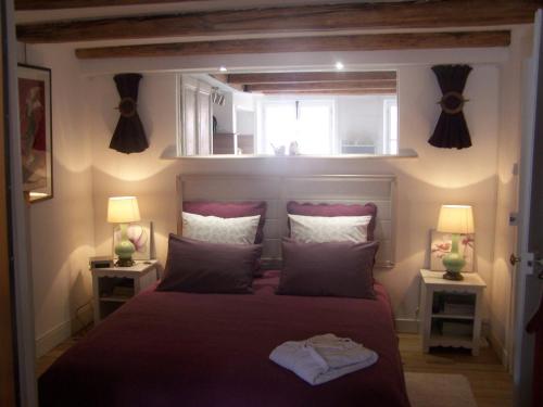 a bedroom with a large bed with two lamps at La Casa Victoria -Stanislas area -Suite 65m2 OR Loft 75m2 in Nancy