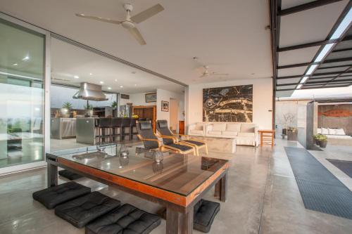 a living room with a table and a couch at Villa Wellmina - Stunning Sunsets & Relaxing Poolside Vibes! in La Paz