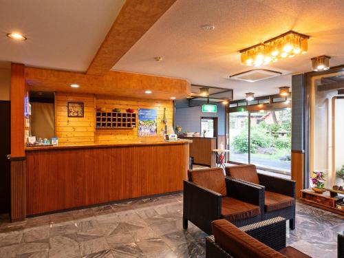 a bar in a restaurant with chairs and a counter at SUIHOUEN in Numazu