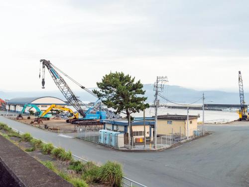 a construction site with a crane on the side of a street at SUIHOUEN in Numazu