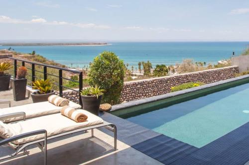a swimming pool with a view of the ocean at Villa Wellmina - Stunning Sunsets & Relaxing Poolside Vibes! in La Paz