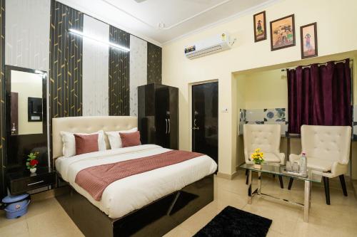 una camera con letto, tavolo e sedie di Ventex Inn a Lucknow