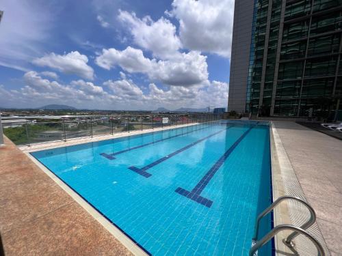 a large swimming pool on the roof of a building at Nick's Homestay @Boulevard mall @ Imperial Suites in Kuching