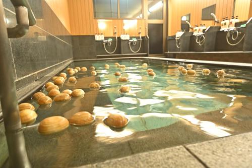 a bunch of donuts in the water in a machine at Watazen Ryokan - Established in 1830 in Kyoto